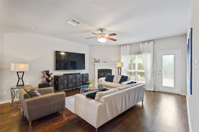 10313 Dimmit Pl, Mckinney, TX 75071 - living room featuring dark wood-style floors, a ceiling fan, a glass covered fireplace, and baseboards