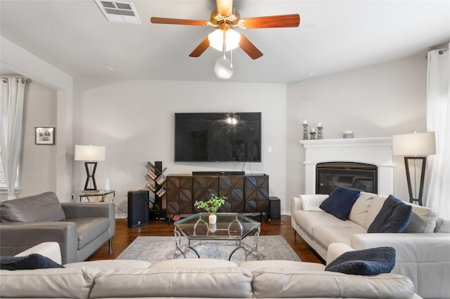 10313 Dimmit Pl, Mckinney, TX 75071 - living room featuring wood finished floors, a ceiling fan, baseboards, and a glass covered fireplace