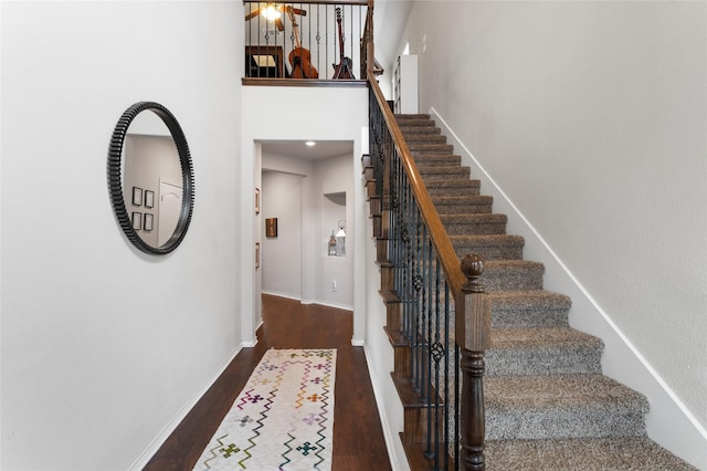 10313 Dimmit Pl, Mckinney, TX 75071 - staircase featuring wood finished floors, baseboards, and a towering ceiling
