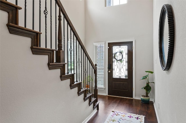 10313 Dimmit Pl, Mckinney, TX 75071 - foyer entrance featuring wood finished floors, stairs, baseboards, and a high ceiling