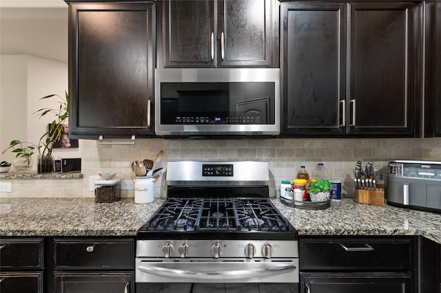 10313 Dimmit Pl, Mckinney, TX 75071 - kitchen with appliances with stainless steel finishes, backsplash, light stone countertops, and dark brown cabinetry