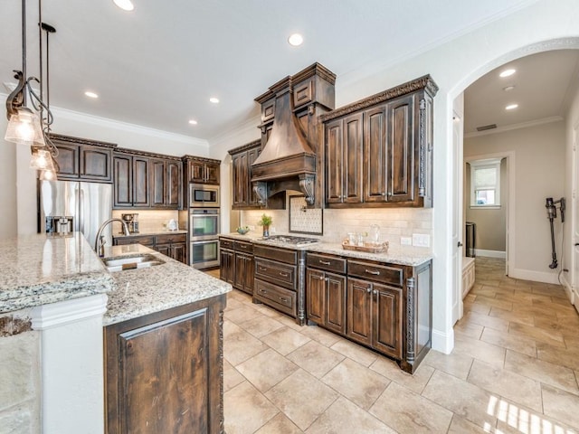 1221 Morris Dr, Keller, TX 76248 - kitchen with a sink, arched walkways, stainless steel appliances, dark brown cabinetry, and ornamental molding