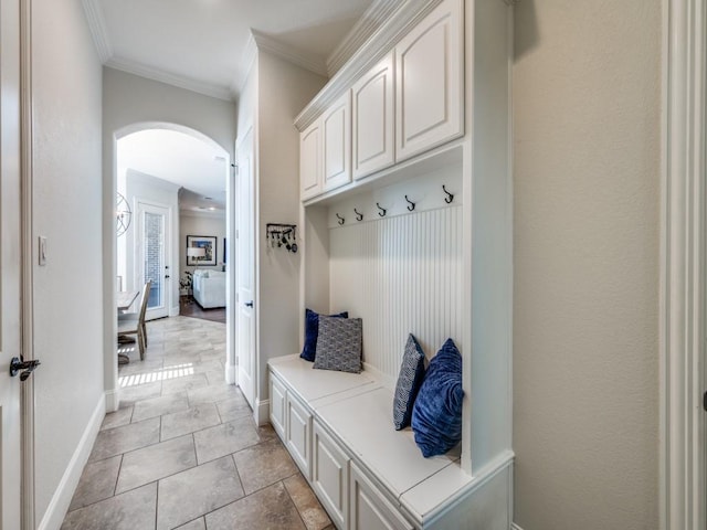 1221 Morris Dr, Keller, TX 76248 - mudroom featuring arched walkways, crown molding, and baseboards