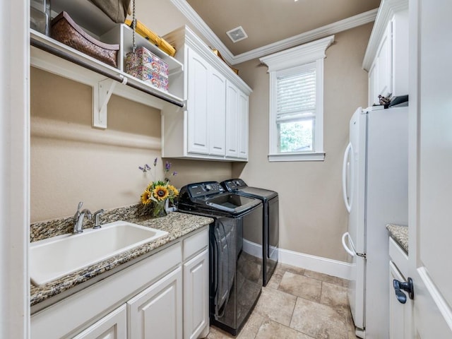 1221 Morris Dr, Keller, TX 76248 - laundry room featuring ornamental molding, separate washer and dryer, baseboards, and cabinet space