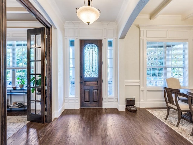1221 Morris Dr, Keller, TX 76248 - foyer featuring wood finished floors, crown molding, a decorative wall, baseboards, and arched walkways