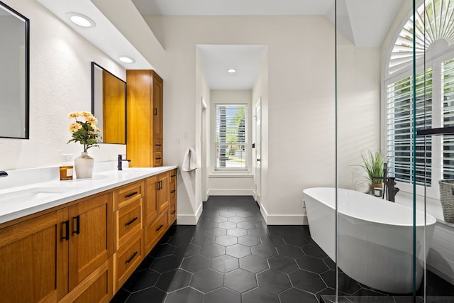 2600 Shadow Hill Ln, Plano, TX 75093 - full bathroom featuring double vanity, a freestanding bath, tile patterned floors, recessed lighting, and baseboards