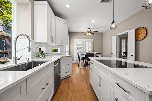 2600 Shadow Hill Ln, Plano, TX 75093 - kitchen with a sink, stainless steel dishwasher, recessed lighting, black electric cooktop, and light wood-style flooring