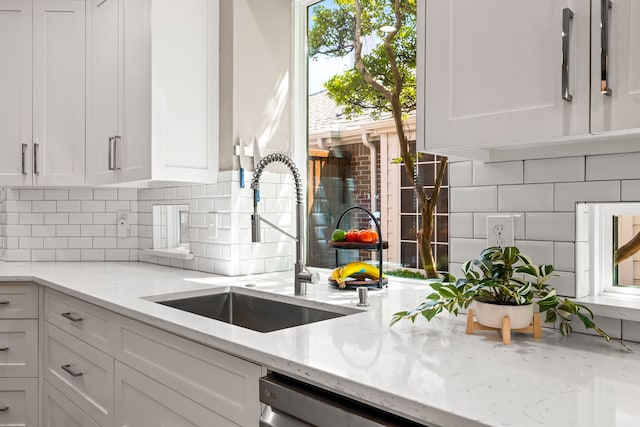 2600 Shadow Hill Ln, Plano, TX 75093 - kitchen featuring a sink, decorative backsplash, white cabinets, and light stone countertops
