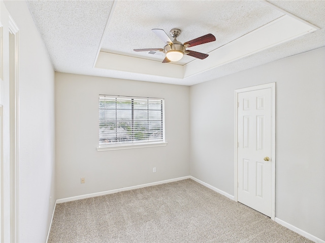 1120 Canyon Ridge Dr, Desoto, TX 75115 - unfurnished room with ceiling fan, carpet flooring, a textured ceiling, a tray ceiling, and baseboards