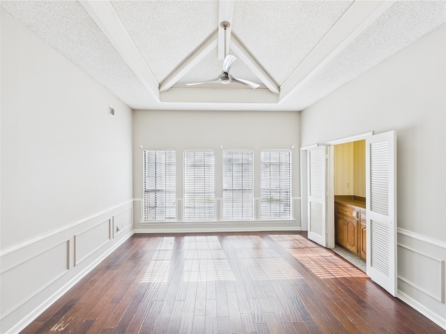 1120 Canyon Ridge Dr, Desoto, TX 75115 - unfurnished room with a ceiling fan, a textured ceiling, dark wood-style floors, and a wainscoted wall