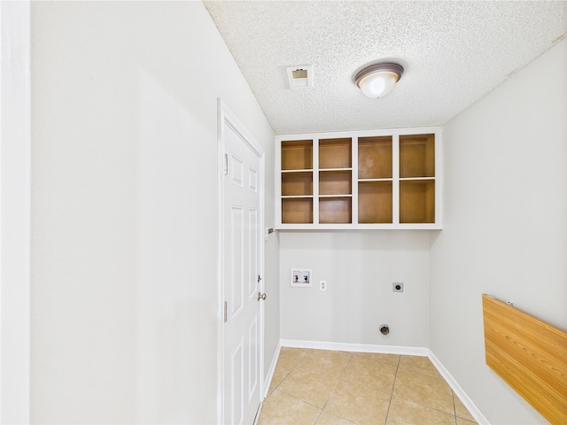 1120 Canyon Ridge Dr, Desoto, TX 75115 - washroom with electric dryer hookup, light tile patterned floors, hookup for a washing machine, a textured ceiling, and baseboards