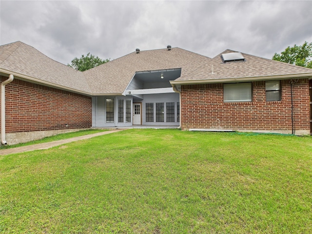 1120 Canyon Ridge Dr, Desoto, TX 75115 - back of house featuring brick siding, a shingled roof, and a yard