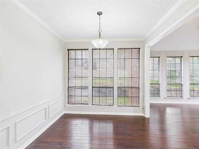 1120 Canyon Ridge Dr, Desoto, TX 75115 - unfurnished dining area with crown molding, dark wood-style flooring, wainscoting, and a textured ceiling