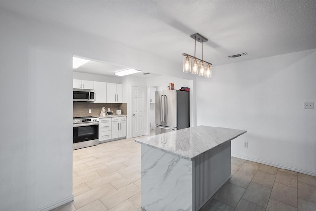 7209 W Cleburne Rd, Fort Worth, TX 76133 - kitchen with appliances with stainless steel finishes, white cabinetry, backsplash, light stone countertops, and decorative light fixtures