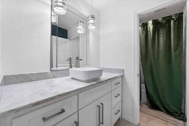 7209 W Cleburne Rd, Fort Worth, TX 76133 - bathroom featuring vanity, shower / bath combination with curtain, and a textured wall