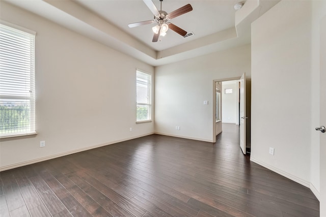 9641 Calaveras Rd, Fort Worth, TX 76177 - spare room with a ceiling fan, a tray ceiling, dark wood-style flooring, and baseboards