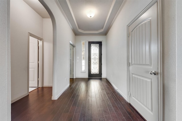 9641 Calaveras Rd, Fort Worth, TX 76177 - foyer entrance featuring arched walkways, dark wood-style floors, baseboards, and a tray ceiling