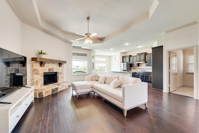 9641 Calaveras Rd, Fort Worth, TX 76177 - living area with a fireplace, a raised ceiling, a ceiling fan, dark wood-type flooring, and recessed lighting