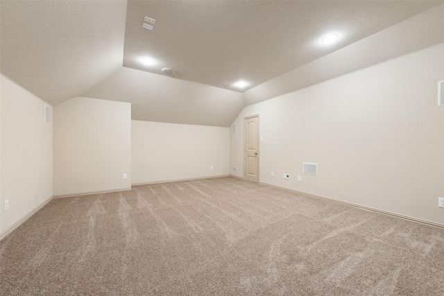 9641 Calaveras Rd, Fort Worth, TX 76177 - bonus room with lofted ceiling, light colored carpet, a textured ceiling, and baseboards