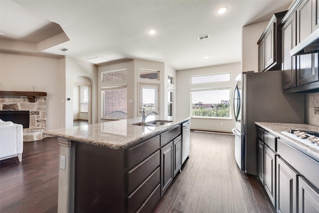 9641 Calaveras Rd, Fort Worth, TX 76177 - kitchen with a sink, appliances with stainless steel finishes, dark wood-style floors, a center island with sink, and recessed lighting