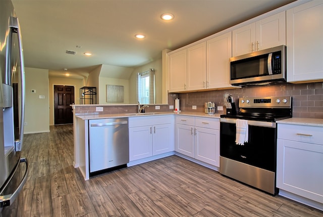 1438 Ganado Dr, Forney, TX 75126 - kitchen featuring stainless steel appliances, decorative backsplash, light countertops, wood finished floors, and recessed lighting