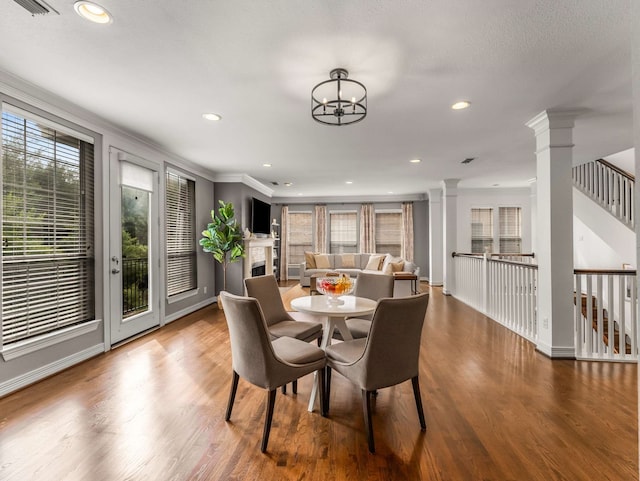 2917 Hallsville St, Dallas, TX 75204 - dining space with decorative columns, wood finished floors, baseboards, recessed lighting, and a fireplace