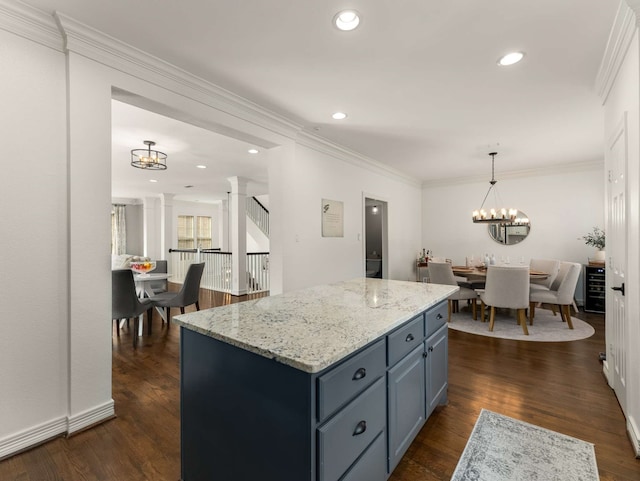 2917 Hallsville St, Dallas, TX 75204 - kitchen featuring a chandelier, ornamental molding, light stone countertops, a kitchen island, and dark wood-style floors