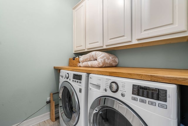 2917 Hallsville St, Dallas, TX 75204 - laundry room featuring washing machine and clothes dryer, baseboards, and cabinet space