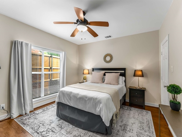 2917 Hallsville St, Dallas, TX 75204 - bedroom featuring dark wood-style flooring, a ceiling fan, and baseboards