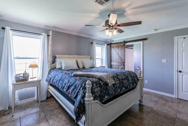 4260 Gun Club Rd, Temple, TX 76501 - bedroom with ornamental molding, a barn door, a ceiling fan, tile patterned flooring, and baseboards