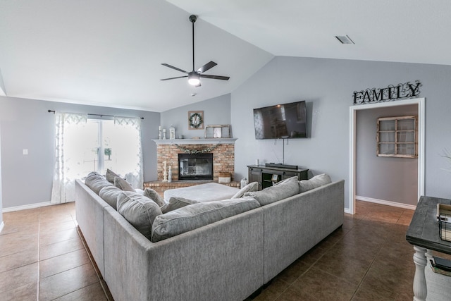 4260 Gun Club Rd, Temple, TX 76501 - tiled living room featuring a ceiling fan, vaulted ceiling, a brick fireplace, and baseboards