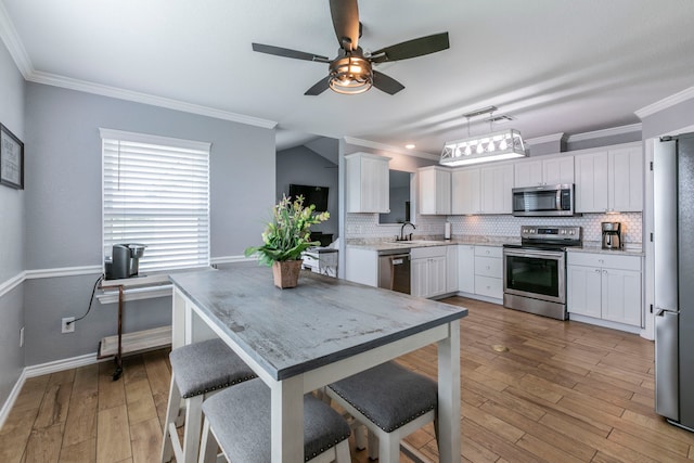 4260 Gun Club Rd, Temple, TX 76501 - kitchen featuring stainless steel appliances, a ceiling fan, a sink, tasteful backsplash, and ornamental molding