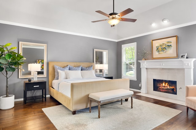 3601 Whitehaven Dr, Plano, TX 75093 - bedroom featuring wood-type flooring, crown molding, a fireplace, baseboards, and vaulted ceiling