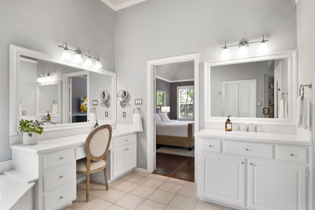 3601 Whitehaven Dr, Plano, TX 75093 - ensuite bathroom featuring two vanities, ornamental molding, tile patterned floors, and baseboards