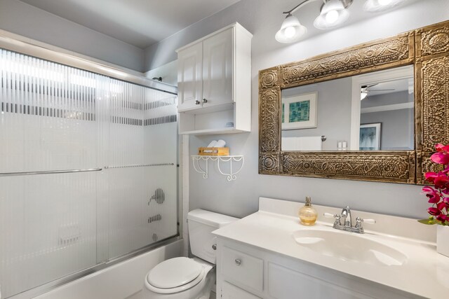 3601 Whitehaven Dr, Plano, TX 75093 - full bathroom with toilet, vanity, combined bath / shower with glass door, and a ceiling fan