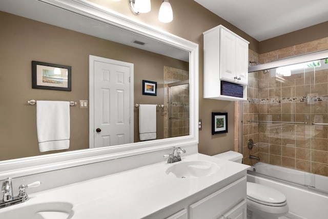 3601 Whitehaven Dr, Plano, TX 75093 - bathroom featuring double vanity, toilet, and bath / shower combo with glass door