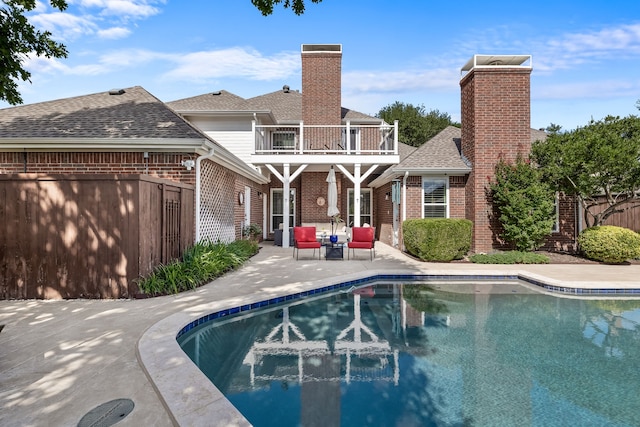 3601 Whitehaven Dr, Plano, TX 75093 - back of property featuring a balcony, brick siding, a patio area, and a chimney