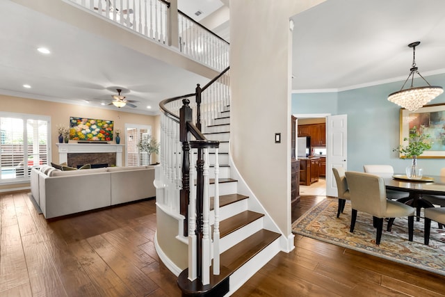 3601 Whitehaven Dr, Plano, TX 75093 - stairs with ceiling fan, ornamental molding, hardwood / wood-style floors, a fireplace, and recessed lighting