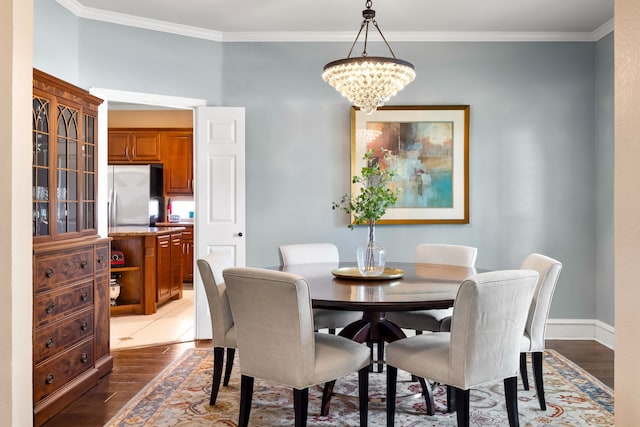 3601 Whitehaven Dr, Plano, TX 75093 - dining space featuring a chandelier, light wood finished floors, crown molding, and baseboards