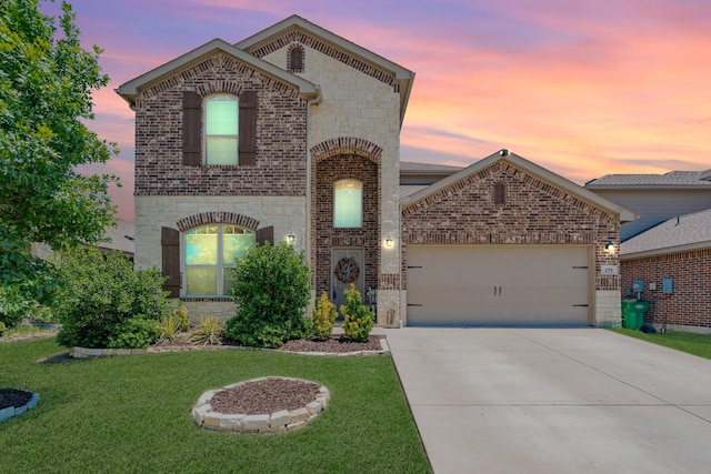 273 Pitt Cir, Fate, TX 75189 - french country inspired facade featuring stone siding, brick siding, an attached garage, and concrete driveway