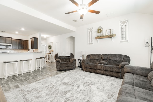 273 Pitt Cir, Fate, TX 75189 - living room featuring ceiling fan, arched walkways, light wood finished floors, and recessed lighting
