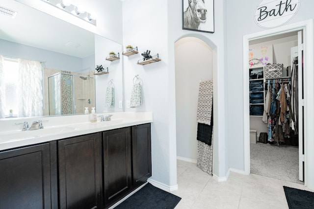 273 Pitt Cir, Fate, TX 75189 - bathroom with a shower stall, a spacious closet, double vanity, and tile patterned floors