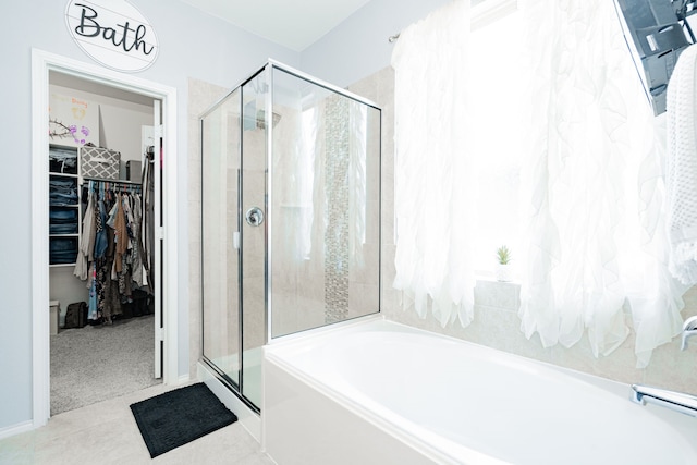 273 Pitt Cir, Fate, TX 75189 - full bath featuring a bath, a stall shower, a walk in closet, and tile patterned flooring