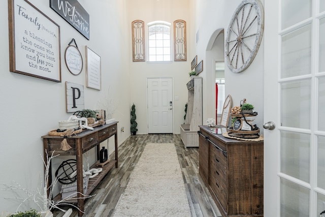 273 Pitt Cir, Fate, TX 75189 - foyer entrance with arched walkways, wood finished floors, a high ceiling, and baseboards