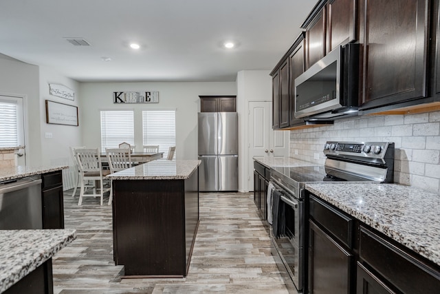 273 Pitt Cir, Fate, TX 75189 - kitchen featuring appliances with stainless steel finishes, a center island, plenty of natural light, light wood-style floors, and recessed lighting