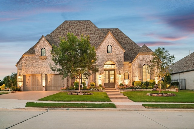 830 Country Brook Ln, Prosper, TX 75078 - view of front of house with french doors, driveway, a front lawn, and brick siding