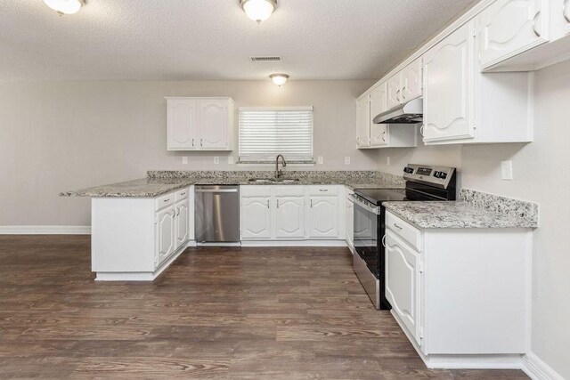 2502 Lake Valley Dr, Garland, TX 75040 - kitchen featuring appliances with stainless steel finishes, a peninsula, a sink, white cabinets, and a textured ceiling