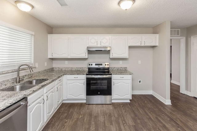2502 Lake Valley Dr, Garland, TX 75040 - kitchen featuring appliances with stainless steel finishes, a sink, white cabinets, dark wood-type flooring, and a textured ceiling