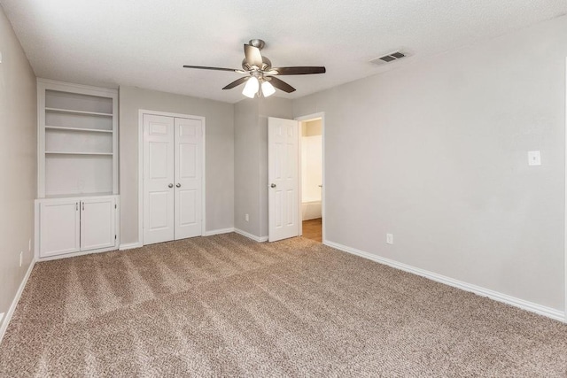 2502 Lake Valley Dr, Garland, TX 75040 - unfurnished bedroom featuring carpet floors, baseboards, ceiling fan, a textured ceiling, and a closet