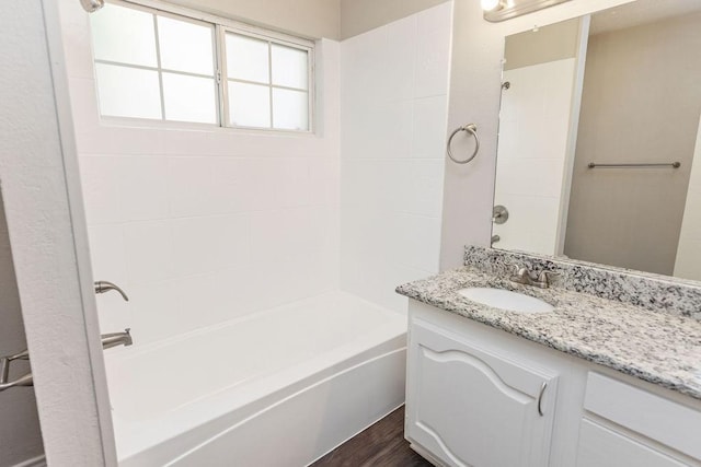 2502 Lake Valley Dr, Garland, TX 75040 - bathroom with vanity, shower / washtub combination, and wood finished floors